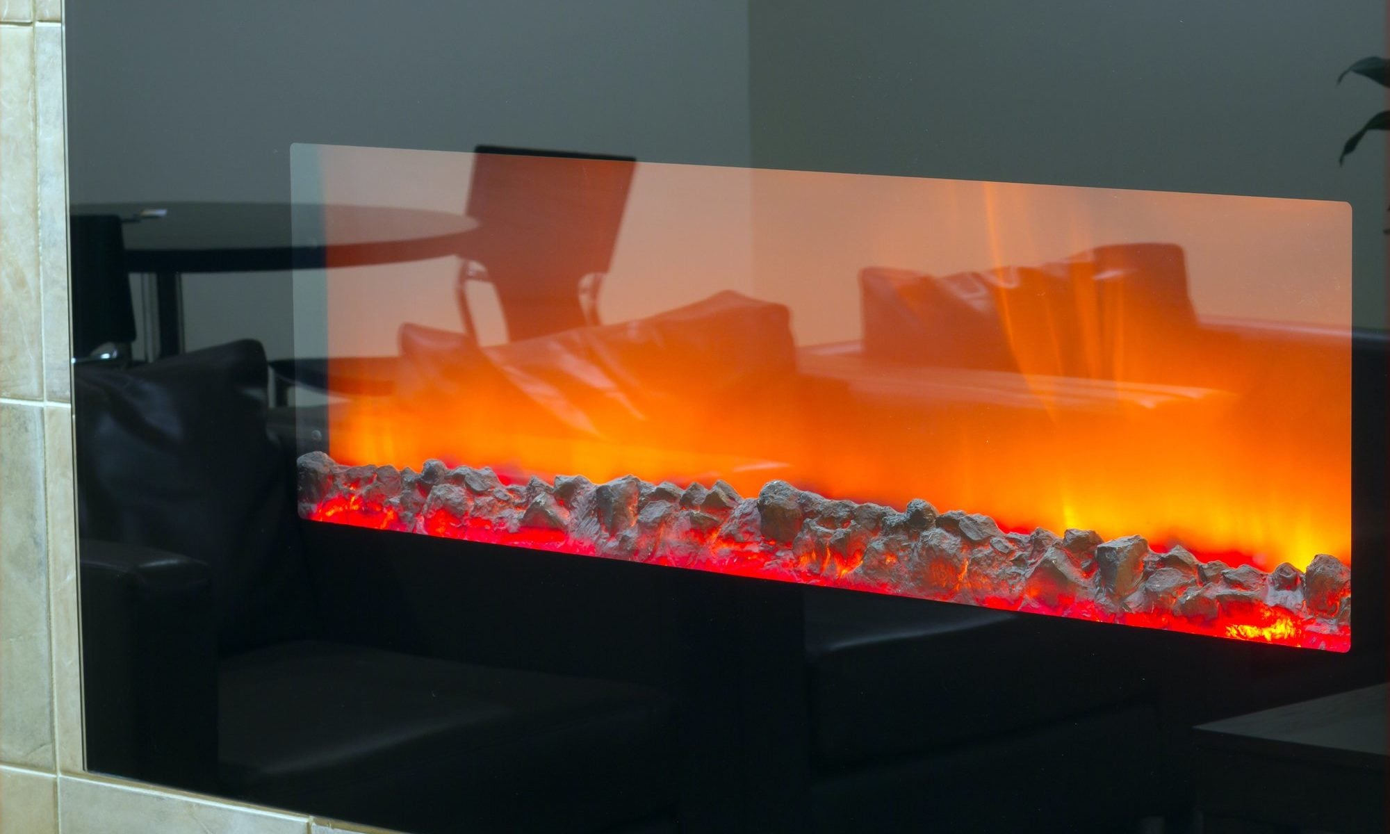 Electric fireplace with a burning coals and red-orange background